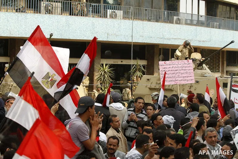 Anti-government protesters gather in front the state television building in Cairo, Egypt, Friday, Feb. 11, 2011. Mubarak has refused to step down or leave the country, and instead handed his administrative powers to his...