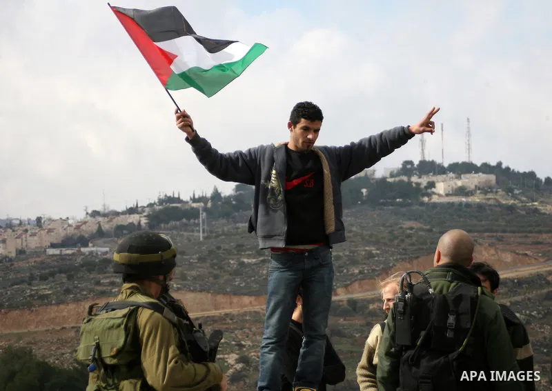 Israeli soldiers restrain Palestinian ,Israeli and foreign protesters during a protest against Israel's controversial separation barrier in the West Bank village of Massarah,near the biblical town of Bethlehem, on Februa...