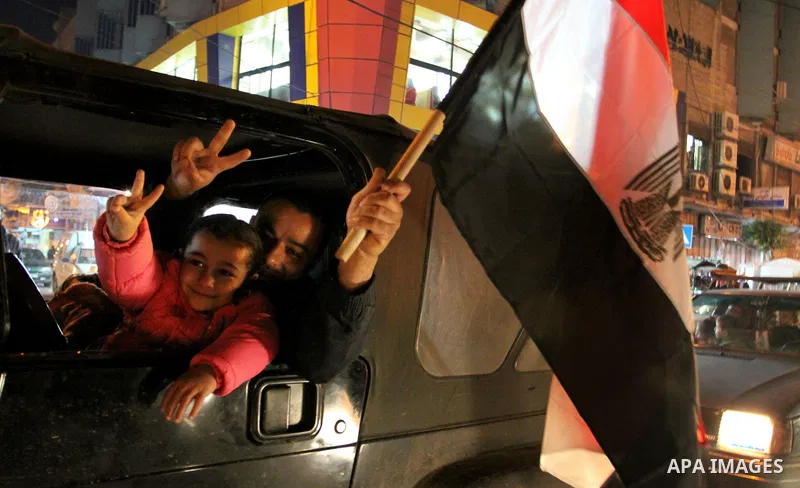 Palestinians celebrate the news of the resignation of President Hosni Mubarak, who handed control of the country to the military, at night in Gaza city, Friday, Feb. 11, 2011 Photo by Naaman Omar