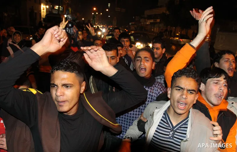 Palestinians celebrate the news of the resignation of President Hosni Mubarak, who handed control of the country to the military, at night in Gaza city, Friday, Feb. 11, 2011 Photo by Naaman Omar