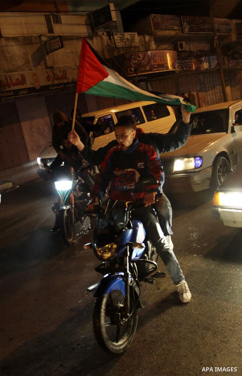 Palestinians celebrate the news of the resignation of President Hosni Mubarak, who handed control of the country to the military, at night in Gaza city, Friday, Feb. 11, 2011 Photo by Naaman Omar