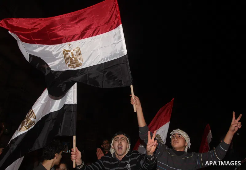 Palestinians celebrate the news of the resignation of President Hosni Mubarak, who handed control of the country to the military, at night in Gaza city, Friday, Feb. 11, 2011 Photo by Mohamed Asad