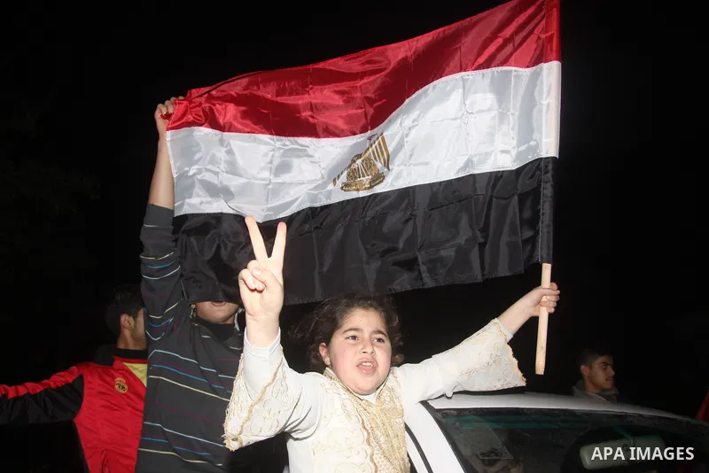 Palestinians celebrate the news of the resignation of President Hosni Mubarak, who handed control of the country to the military, at night in Gaza city, Friday, Feb. 11, 2011 Photo by Mohamed Asad
