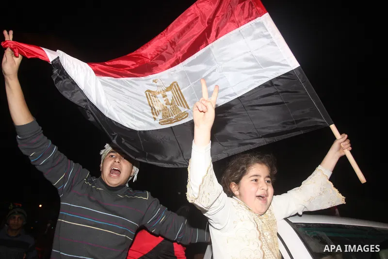 Palestinians celebrate the news of the resignation of President Hosni Mubarak, who handed control of the country to the military, at night in Gaza city, Friday, Feb. 11, 2011 Photo by Mohamed Asad