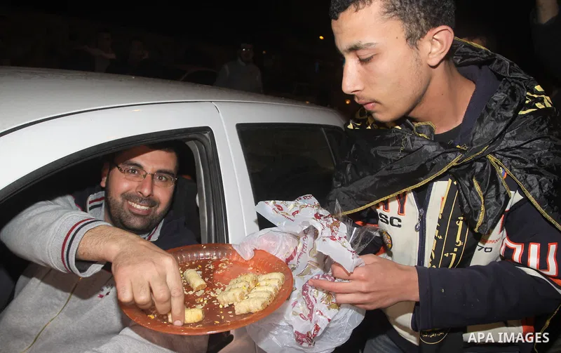 Palestinians celebrate the news of the resignation of President Hosni Mubarak, who handed control of the country to the military, at night in Gaza city, Friday, Feb. 11, 2011 Photo by Mohamed Asad
