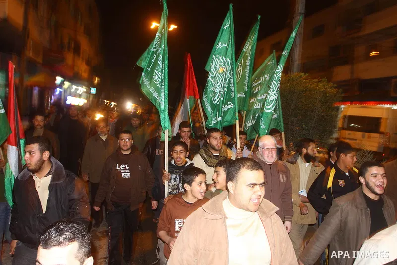 Palestinian Hamas supporters celebrate the news of the resignation of President Hosni Mubarak, who handed control of the country to the military, at night in Deir al-Balah in the central Gaza Strip, Friday, Feb. 11, 2011...