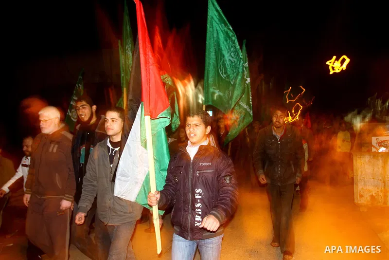 Palestinian Hamas supporters celebrate the news of the resignation of President Hosni Mubarak, who handed control of the country to the military, at night in Deir al-Balah in the central Gaza Strip, Friday, Feb. 11, 2011...