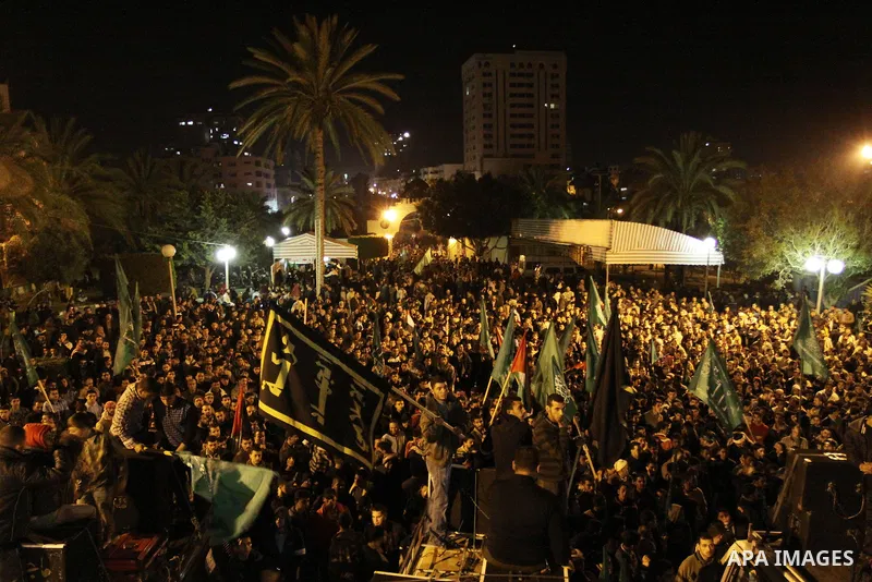 Palestinian Hamas supporters celebrate the news of the resignation of President Hosni Mubarak, who handed control of the country to the military, at night in Deir al-Balah in the central Gaza Strip, Friday, Feb. 11, 2011...