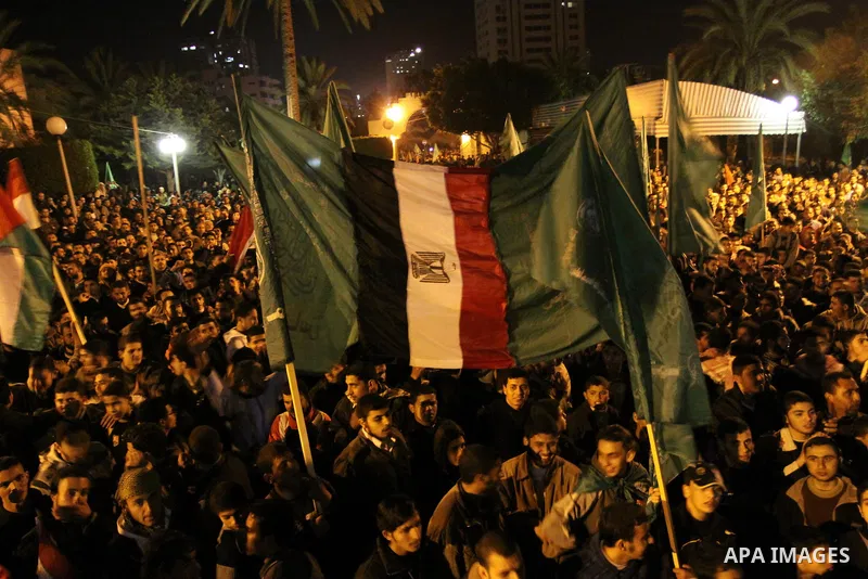 Palestinian Hamas supporters celebrate the news of the resignation of President Hosni Mubarak, who handed control of the country to the military, at night in Deir al-Balah in the central Gaza Strip, Friday, Feb. 11, 2011...