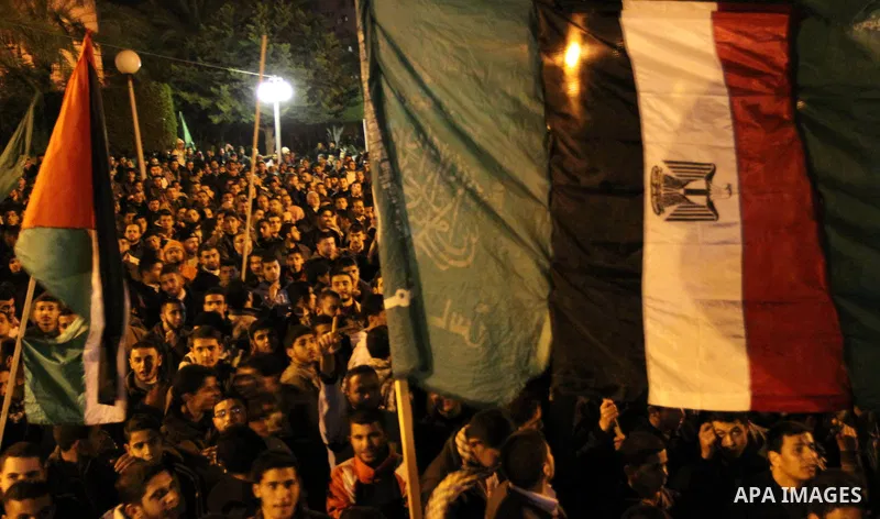 Palestinian Hamas supporters celebrate the news of the resignation of President Hosni Mubarak, who handed control of the country to the military, at night in Deir al-Balah in the central Gaza Strip, Friday, Feb. 11, 2011...
