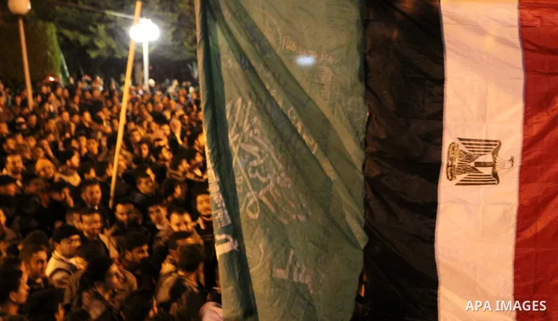 Palestinian Hamas supporters celebrate the news of the resignation of President Hosni Mubarak, who handed control of the country to the military, at night in Deir al-Balah in the central Gaza Strip, Friday, Feb. 11, 2011...