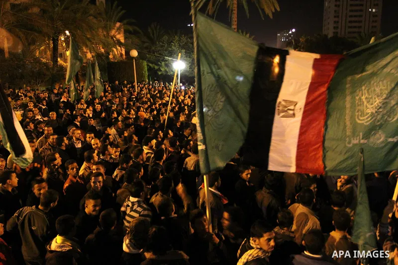 Palestinian Hamas supporters celebrate the news of the resignation of President Hosni Mubarak, who handed control of the country to the military, at night in Deir al-Balah in the central Gaza Strip, Friday, Feb. 11, 2011...