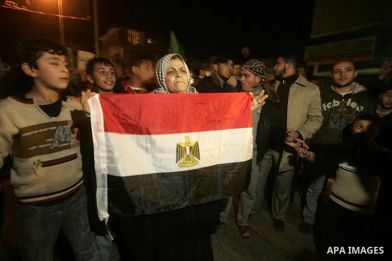 Palestinians celebrate the news of the resignation of President Hosni Mubarak, who handed control of the country to the military, at night in Rafah, southern Gaza Strip, Friday, Feb. 11, 2011. Photo by Abed Rahim Khatib