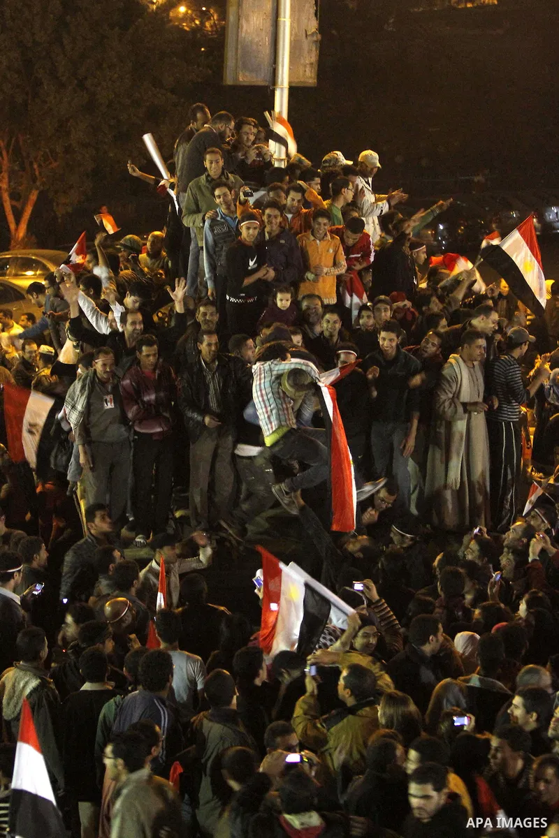 Egyptians celebrate the news of the resignation of President Hosni Mubarak, who handed control of the country to the military, at night in Tahrir Square in downtown Cairo, Egypt Friday, Feb. 11, 2011. Photo by Karam Nass...