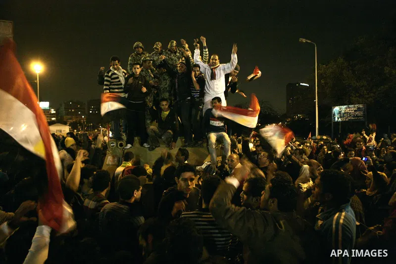 Egyptians celebrate the news of the resignation of President Hosni Mubarak, who handed control of the country to the military, at night in Tahrir Square in downtown Cairo, Egypt Friday, Feb. 11, 2011. Photo by Karam Nass...