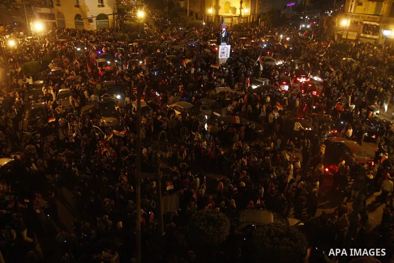 Egyptians celebrate the news of the resignation of President Hosni Mubarak, who handed control of the country to the military, at night in Tahrir Square in downtown Cairo, Egypt Friday, Feb. 11, 2011. Photo by Ahmed Asad