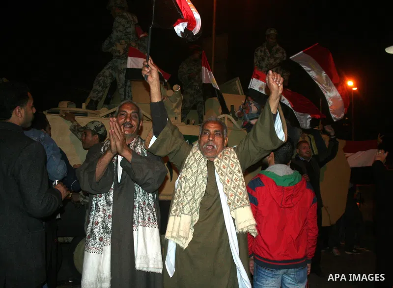 Egyptians celebrate the news of the resignation of President Hosni Mubarak, who handed control of the country to the military, at night in Tahrir Square in downtown Cairo, Egypt Friday, Feb. 11, 2011. Photo by Ahmed Asad