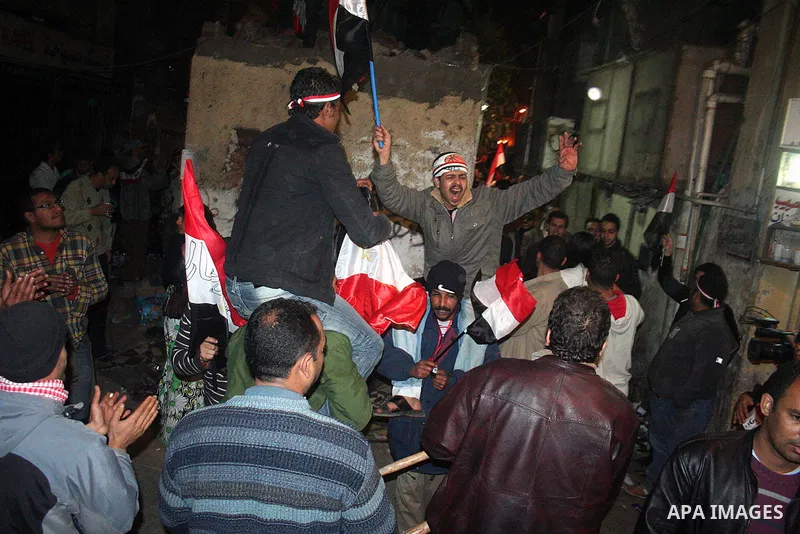 Egyptians celebrate the news of the resignation of President Hosni Mubarak, who handed control of the country to the military, at night in Tahrir Square in downtown Cairo, Egypt Friday, Feb. 11, 2011. Photo by Ahmed Asad