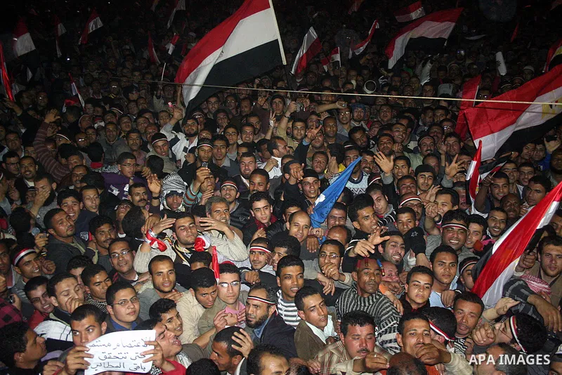 Egyptians celebrate the news of the resignation of President Hosni Mubarak, who handed control of the country to the military, at night in Tahrir Square in downtown Cairo, Egypt Friday, Feb. 11, 2011. Photo by Ahmed Asad