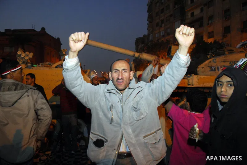 Egyptians celebrate the news of the resignation of President Hosni Mubarak, who handed control of the country to the military, at night in Tahrir Square in downtown Cairo, Egypt Friday, Feb. 11, 2011. Photo by Ahmed Asad