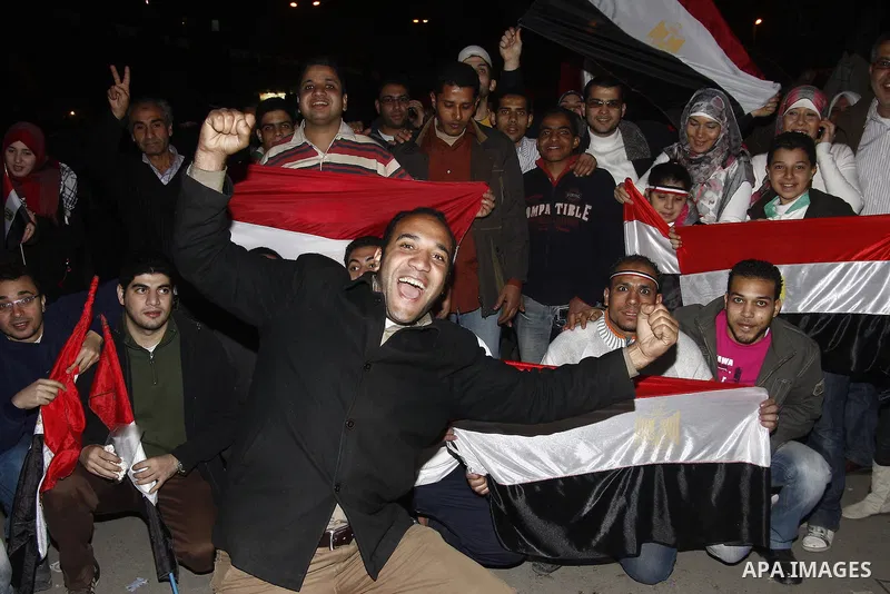 Egyptians celebrate the news of the resignation of President Hosni Mubarak, who handed control of the country to the military, at night in Tahrir Square in downtown Cairo, Egypt Friday, Feb. 11, 2011. Photo by Ahmed Asad