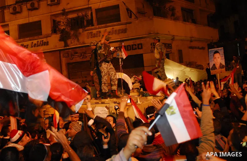 Egyptians celebrate the news of the resignation of President Hosni Mubarak, who handed control of the country to the military, at night in Tahrir Square in downtown Cairo, Egypt Friday, Feb. 11, 2011. Photo by Ahmed Asad