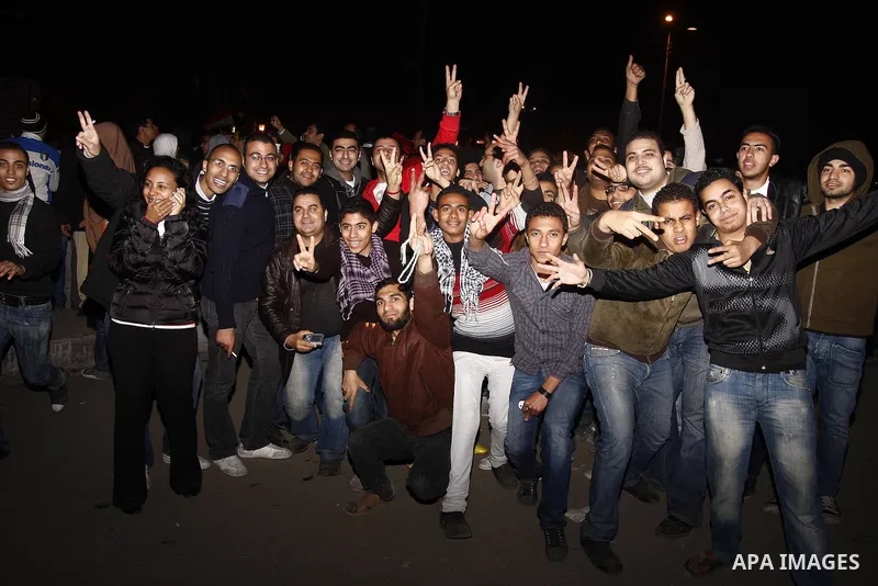 Egyptians celebrate the news of the resignation of President Hosni Mubarak, who handed control of the country to the military, at night in Tahrir Square in downtown Cairo, Egypt Friday, Feb. 11, 2011. Photo by Ahmed Asad