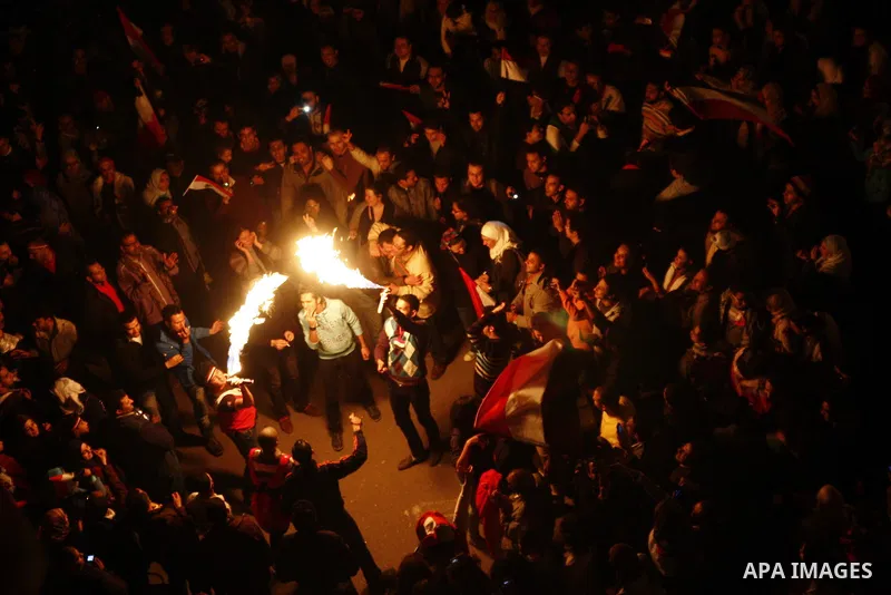 Egyptians celebrate the news of the resignation of President Hosni Mubarak, who handed control of the country to the military, at night in Tahrir Square in downtown Cairo, Egypt Friday, Feb. 11, 2011. Photo by Ahmed Asad