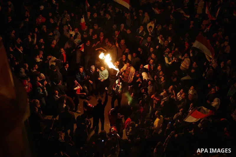 Egyptians celebrate the news of the resignation of President Hosni Mubarak, who handed control of the country to the military, at night in Tahrir Square in downtown Cairo, Egypt Friday, Feb. 11, 2011. Photo by Ahmed Asad