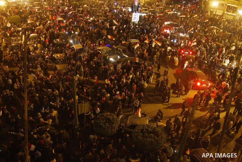 Egyptians celebrate the news of the resignation of President Hosni Mubarak, who handed control of the country to the military, at night in Tahrir Square in downtown Cairo, Egypt Friday, Feb. 11, 2011. Photo by Ahmed Asad