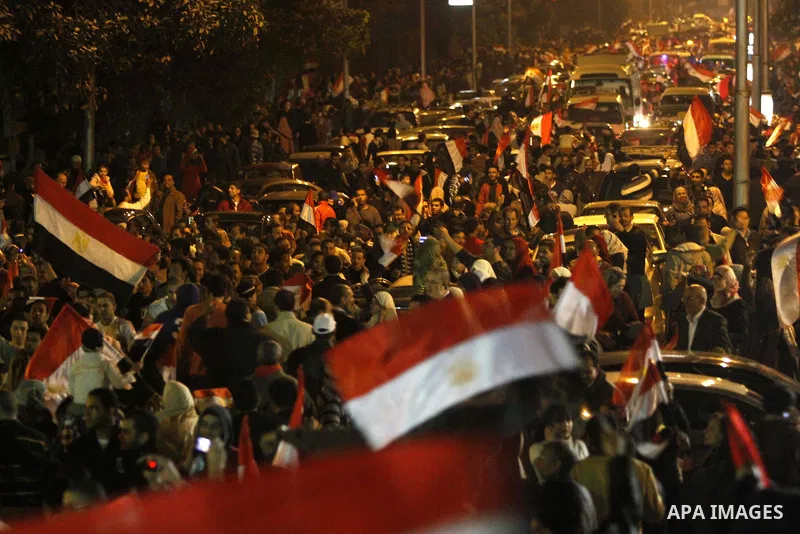 Egyptians celebrate the news of the resignation of President Hosni Mubarak, who handed control of the country to the military, at night in Tahrir Square in downtown Cairo, Egypt Friday, Feb. 11, 2011. Photo by Karam Nass...