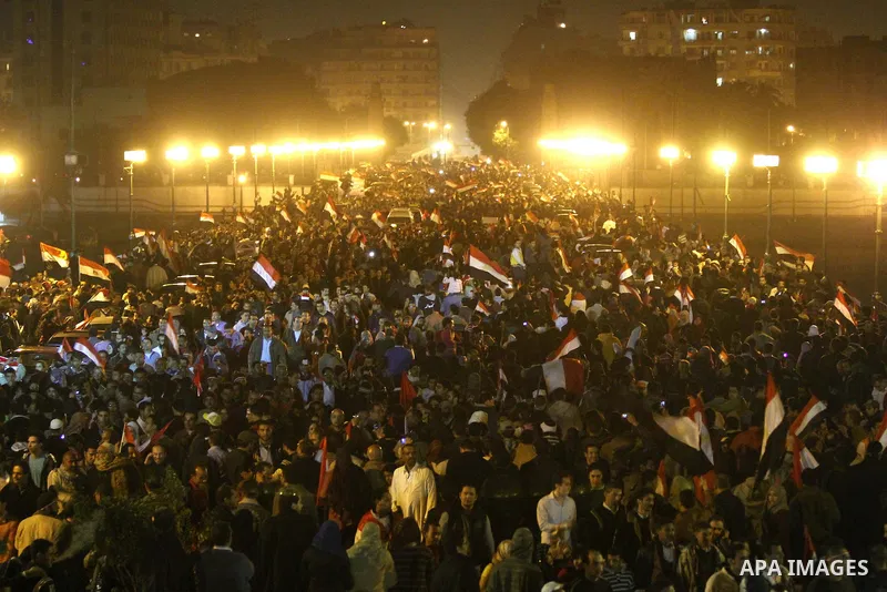 Egyptians celebrate the news of the resignation of President Hosni Mubarak, who handed control of the country to the military, at night in Tahrir Square in downtown Cairo, Egypt Friday, Feb. 11, 2011. Photo by Karam Nass...