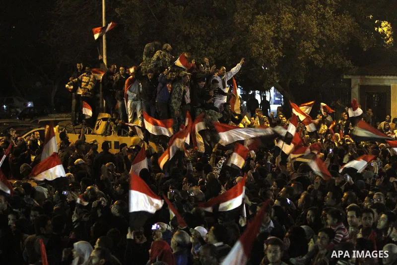 Egyptians celebrate the news of the resignation of President Hosni Mubarak, who handed control of the country to the military, at night in Tahrir Square in downtown Cairo, Egypt Friday, Feb. 11, 2011. Photo by Karam Nass...