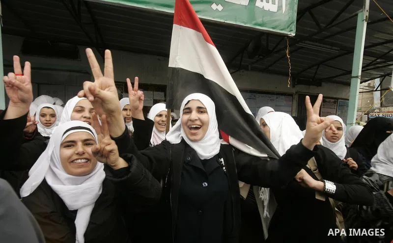 Palestinian students participate in a rally celebrating the resignation of Egyptian President Hosni Mubarak, in southern Gaza Strip town of Rafah on Feb. 12, 2011. Photo by Abed Rahim Khatib