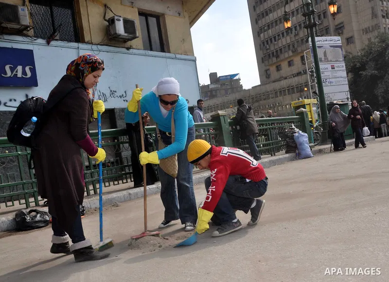 Egyptians clean up garbage and rocks from a street near Tahrir Square in downtown Cairo, Egypt, Saturday, Feb. 12, 2011. Egyptian protesters were jubilant Saturday over their success in ousting former President Hosni Mub...