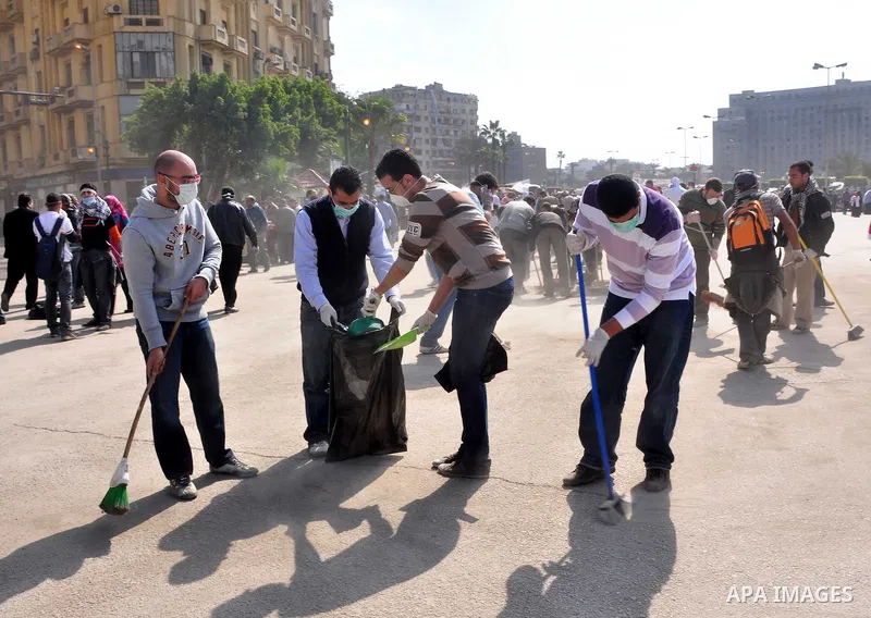 Egyptians clean up garbage and rocks from a street near Tahrir Square in downtown Cairo, Egypt, Saturday, Feb. 12, 2011. Egyptian protesters were jubilant Saturday over their success in ousting former President Hosni Mub...