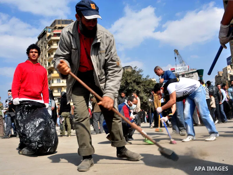 Egyptians clean up garbage and rocks from a street near Tahrir Square in downtown Cairo, Egypt, Saturday, Feb. 12, 2011. Egyptian protesters were jubilant Saturday over their success in ousting former President Hosni Mub...