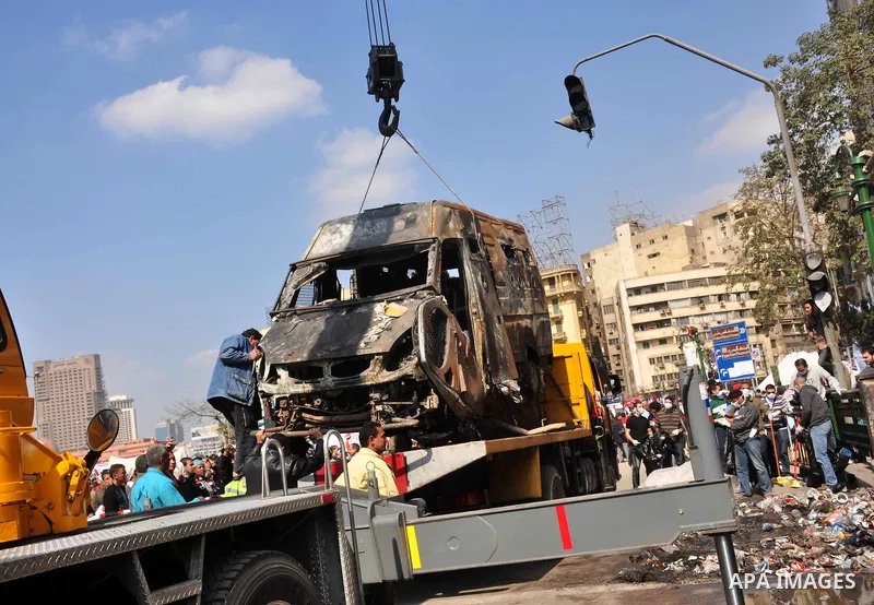 Egyptians clean up garbage and rocks from a street near Tahrir Square in downtown Cairo, Egypt, Saturday, Feb. 12, 2011. Egyptian protesters were jubilant Saturday over their success in ousting former President Hosni Mub...