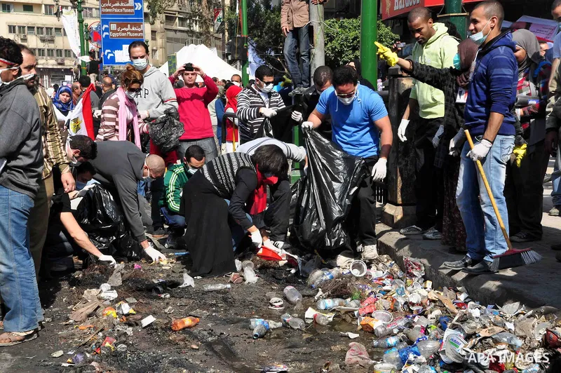 Egyptians clean up garbage and rocks from a street near Tahrir Square in downtown Cairo, Egypt, Saturday, Feb. 12, 2011. Egyptian protesters were jubilant Saturday over their success in ousting former President Hosni Mub...