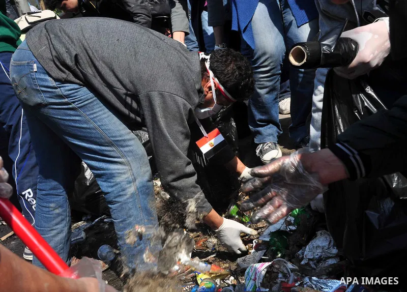 Egyptians clean up garbage and rocks from a street near Tahrir Square in downtown Cairo, Egypt, Saturday, Feb. 12, 2011. Egyptian protesters were jubilant Saturday over their success in ousting former President Hosni Mub...