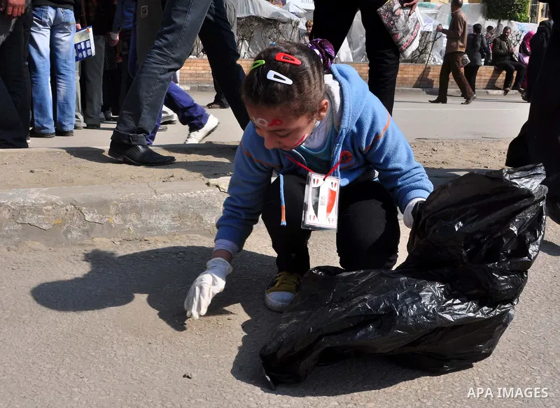 Egyptians clean up garbage and rocks from a street near Tahrir Square in downtown Cairo, Egypt, Saturday, Feb. 12, 2011. Egyptian protesters were jubilant Saturday over their success in ousting former President Hosni Mub...