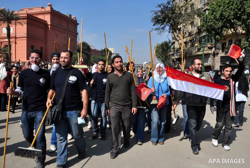 Egyptians clean up garbage and rocks from a street near Tahrir Square in downtown Cairo, Egypt, Saturday, Feb. 12, 2011. Egyptian protesters were jubilant Saturday over their success in ousting former President Hosni Mub...