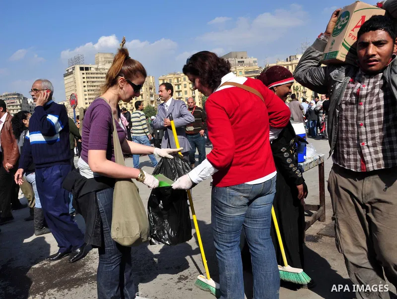 Egyptians clean up garbage and rocks from a street near Tahrir Square in downtown Cairo, Egypt, Saturday, Feb. 12, 2011. Egyptian protesters were jubilant Saturday over their success in ousting former President Hosni Mub...