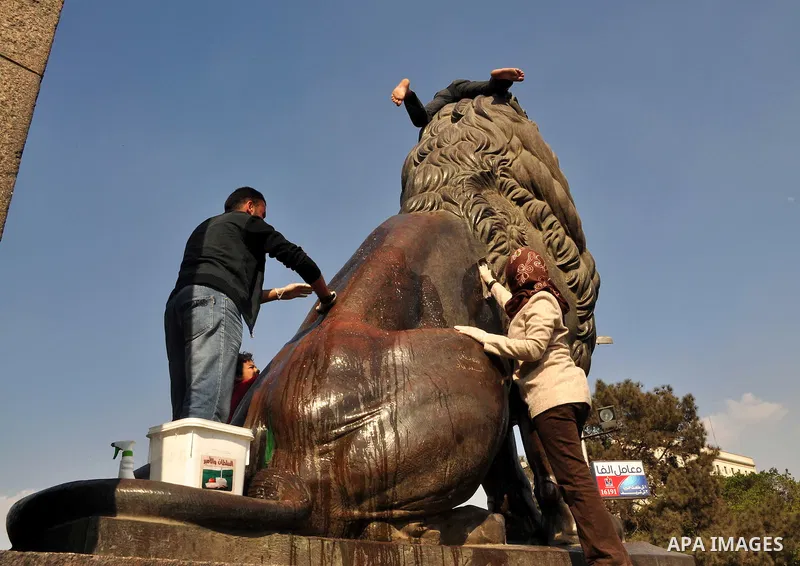 Egyptians clean up garbage and rocks from a street near Tahrir Square in downtown Cairo, Egypt, Saturday, Feb. 12, 2011. Egyptian protesters were jubilant Saturday over their success in ousting former President Hosni Mub...