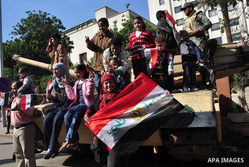Egyptians celebrate and wave national flags in Tahrir Square in Cairo, Egypt, Saturday, Feb. 12, 2011. Egypt exploded with joy, tears, and relief after pro-democracy protesters brought down President Hosni Mubarak with a...