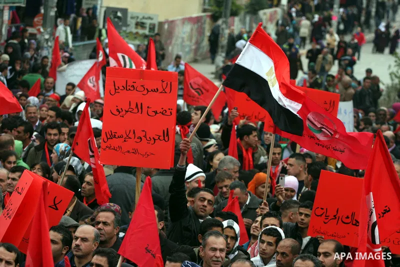 Palestinians wave an Egyptian flag and red flags during a demonstration marking the 29th anniversary of the Palestinian People's Party, a socialist political party, in the West Bank city of Ramallah, Saturday, Feb. 12, 2...