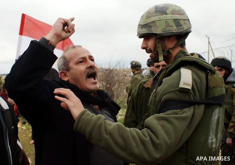 A Palestinian demonstrator argues with an Israeli soldier during a protest against Israel's controversial separation barrier organized by Palestinian and foreign peace activists in the West Bank village of Beit Omar, nea...