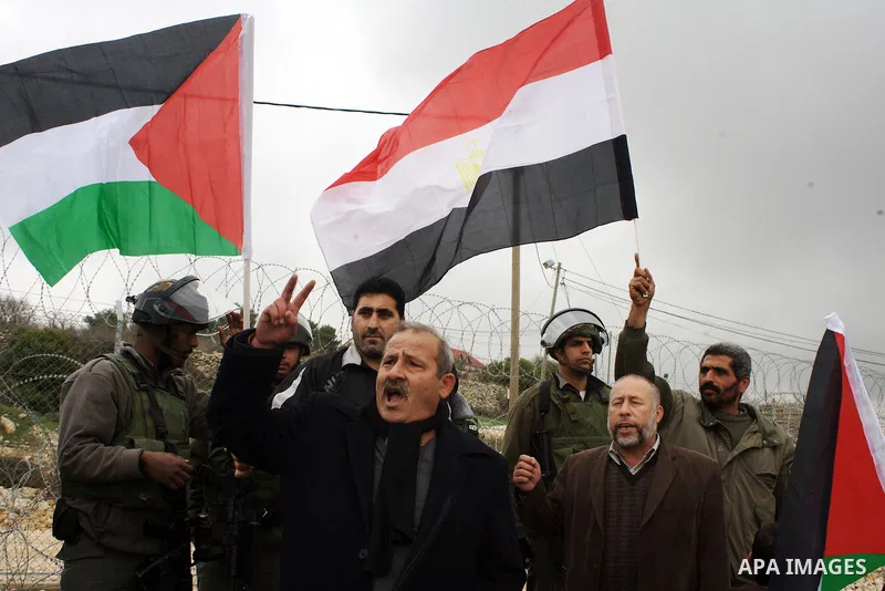 Palestinian demonstrators argue with an Israeli soldiers during a protest against Israel's controversial separation barrier organized by Palestinian and foreign peace activists in the West Bank village of Beit Omar, near...