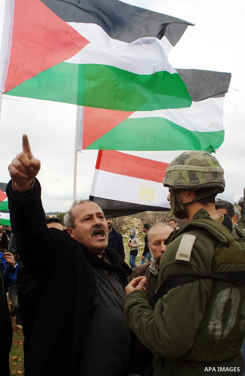 A Palestinian demonstrator argues with an Israeli soldier during a protest against Israel's controversial separation barrier organized by Palestinian and foreign peace activists in the West Bank village of Beit Omar, nea...