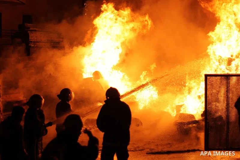 Palestinian civil defense forces try to stop fire burning in carpentry workshop and a factory for plastic materials, in the area of Doha, in Bethlehem on February 12, 2011. Photo by Najeh Hashlamoun